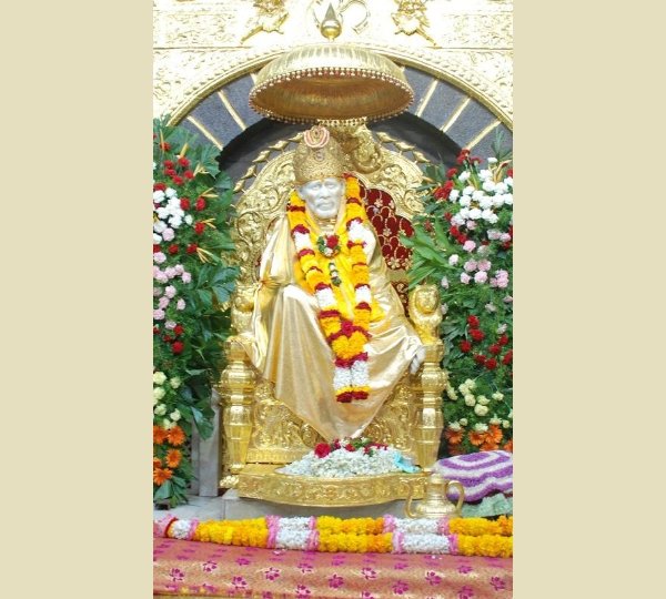 Devotees visiting Shri Sai Baba Temple in Shirdi with Vasantkamal Tours, offering Shirdi tour packages from Ahmedabad by flight, VIP Darshan, Kakad Aarti assistance, 4-star hotel accommodation, airport transfers, and guided pilgrimage.